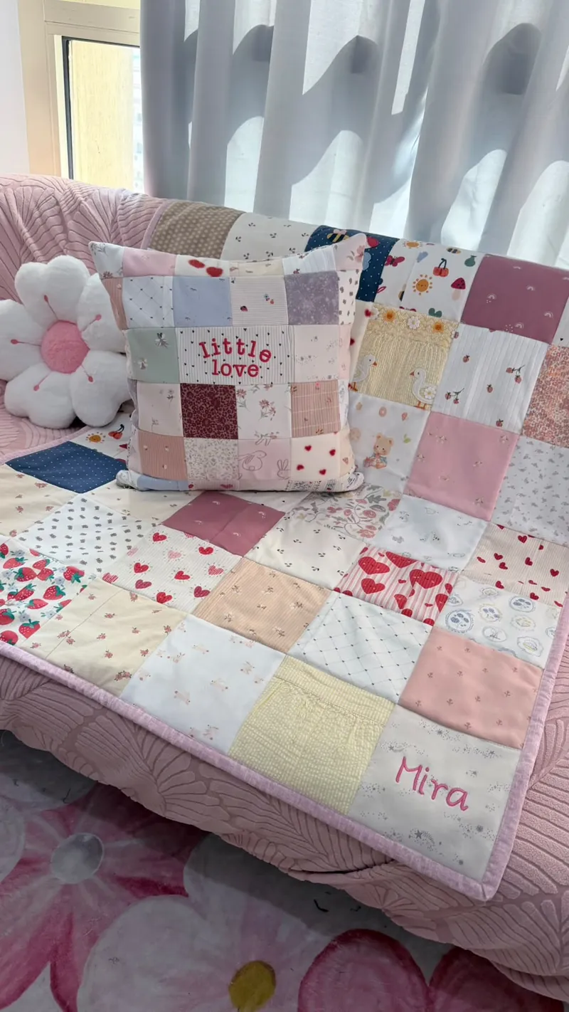 Pink memory quilt embroidered with Mira, with a matching 'little love' cushion